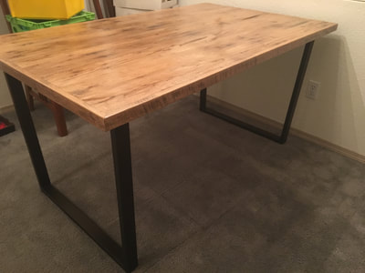 Modern, rustic, and industrial reclaimed white oak wood table with bronze powder coated steel legs.