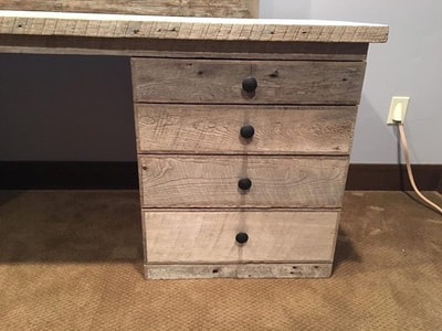 This picture shows the right side drawer stack of this modern gray reclaimed wood. The drawer fronts and knobs are featured.