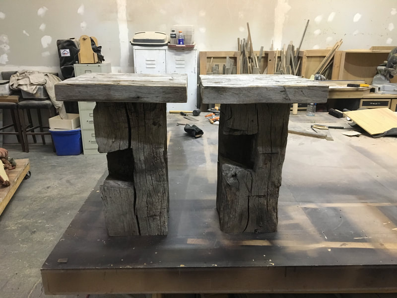This shows the pair of gray hand hewn sidetables.