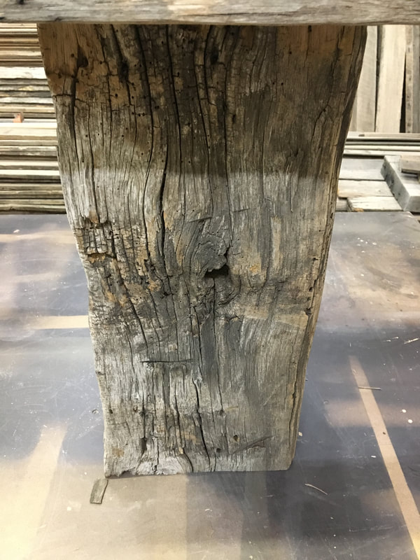 This picture shows one side of the gray hand hewn white oak side tables. 
