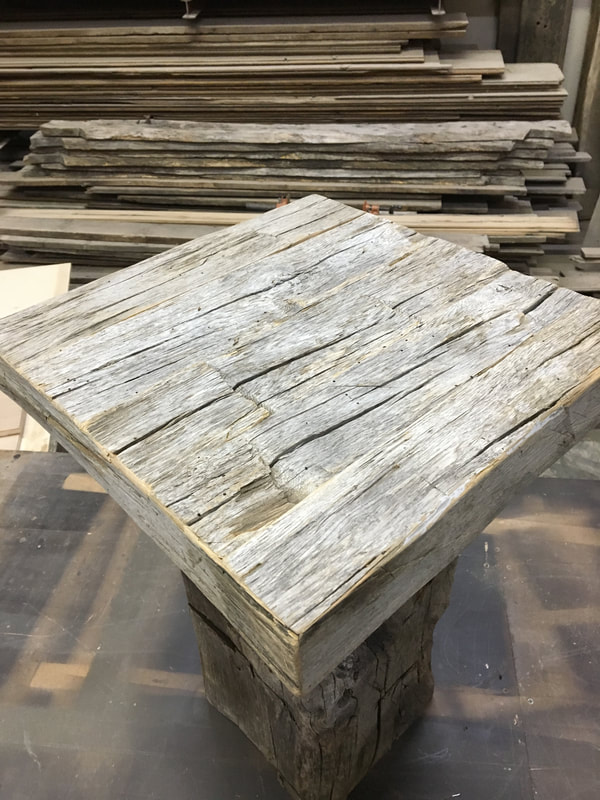 This shows the top to one of the gray hand hewn white oak side tables.