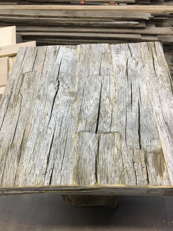 This shows the top to one of the gray hand hewn white oak side tables.