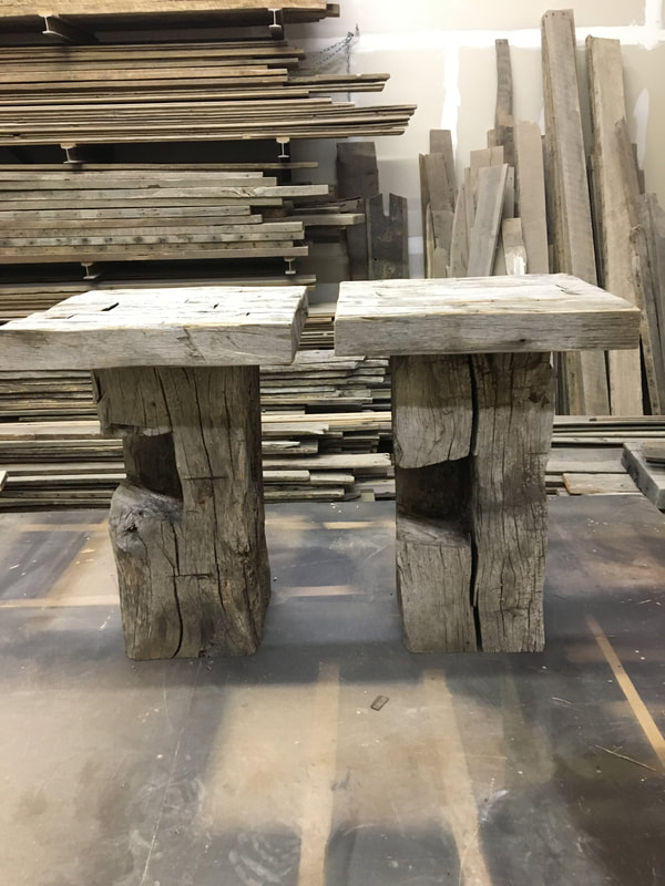 This shows the pair of gray hand hewn sidetables.