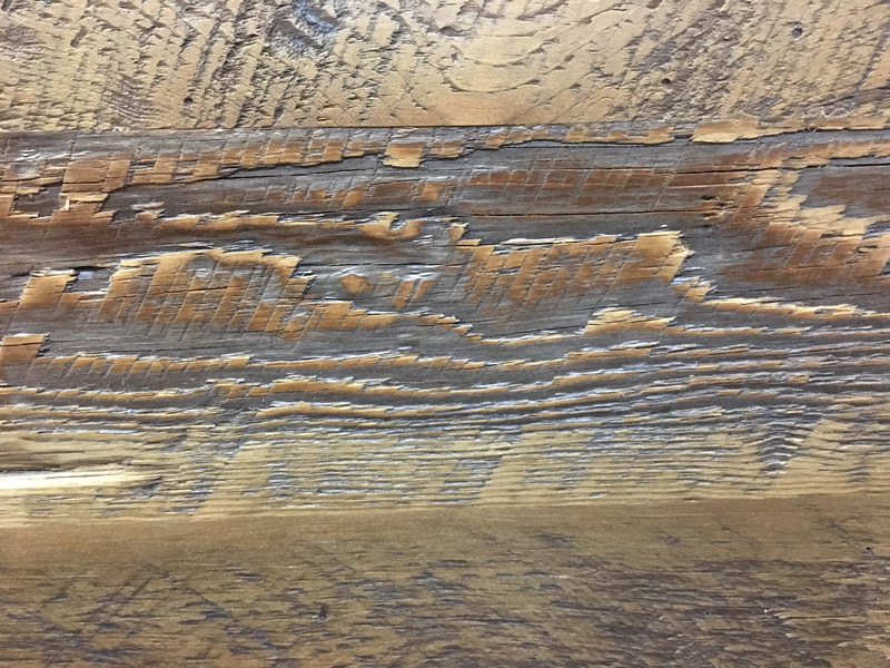 Close up view of some of the wood grain on the headboard of the reclaimed wood beam bed frame.