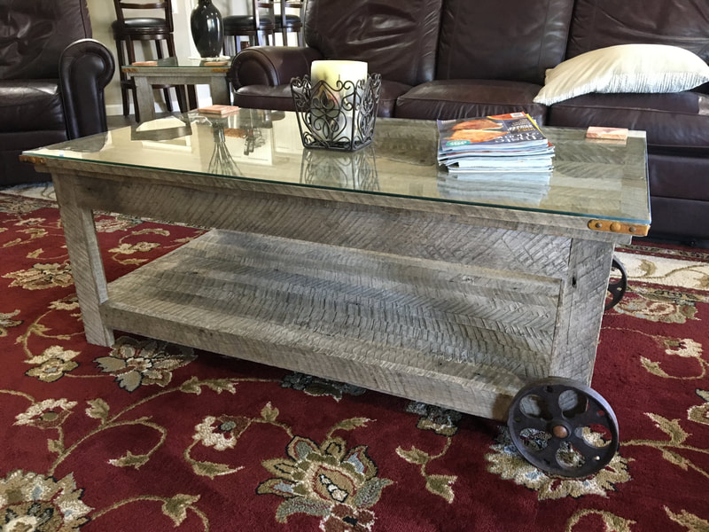 Back view of the antique wheel and gray reclaimed wood coffee table.