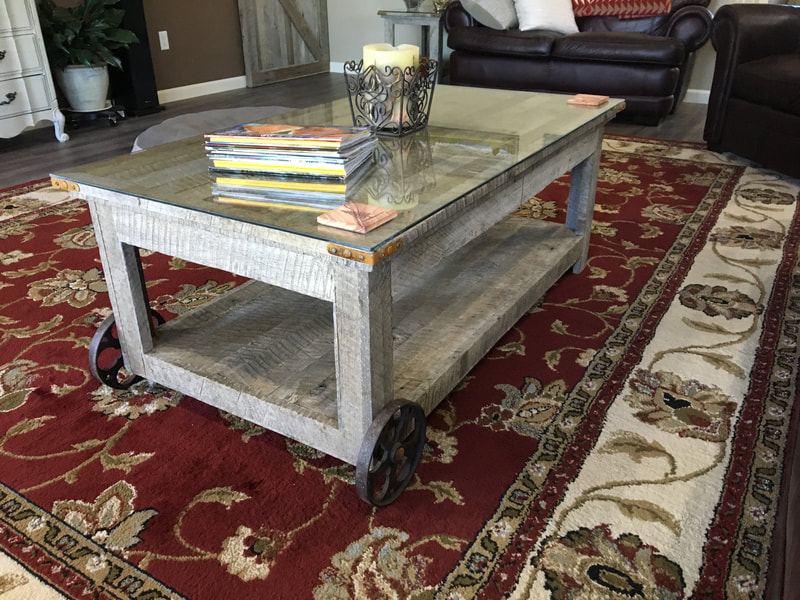 Angled view of the side of the antique wheel and reclaimed wood coffee table.