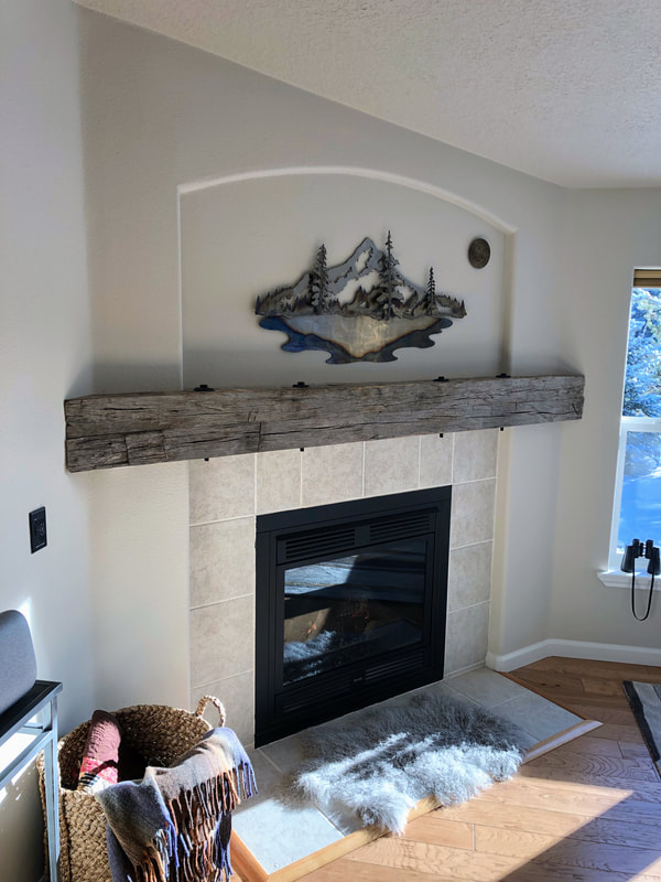 This shows the entire gray hand hewn white oak mantlepiece.