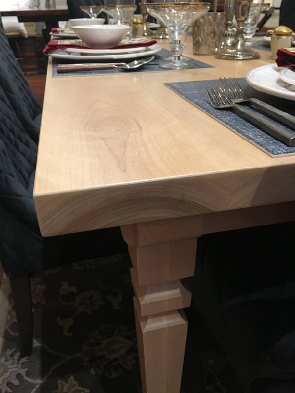 Close up view showing the corner of the custom made birch dining table.