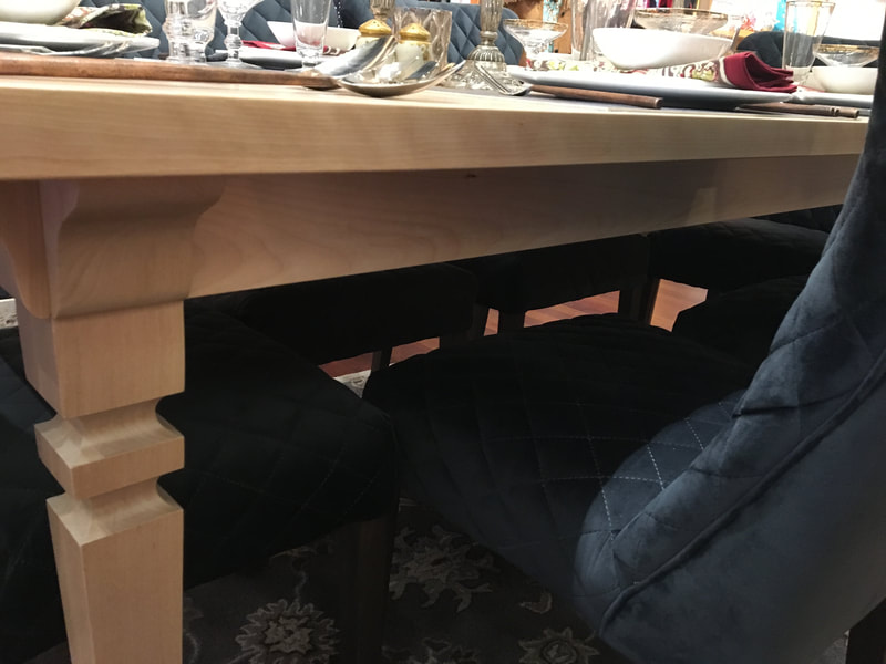 View showing the corbels, tapered legs, and skirt on the birch dining table. This picture shows the traditional aspects of table. 