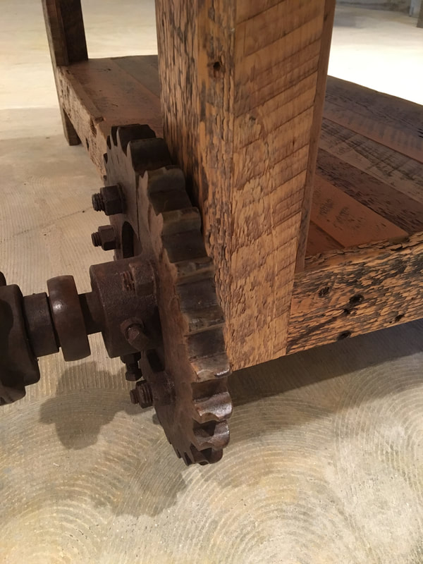 Close up view of the antique cog on the reclaimed wood coffee table.