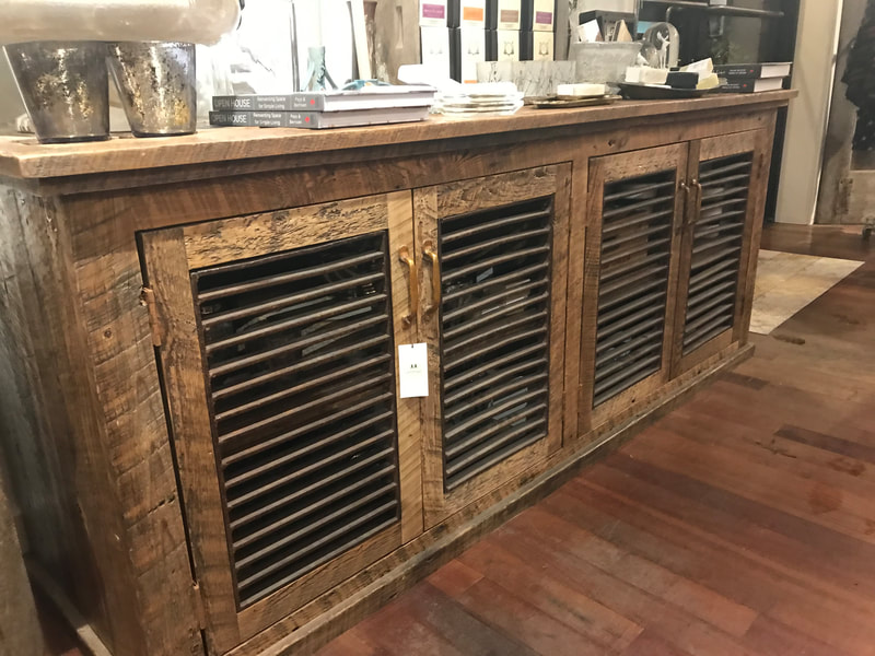 Angled view of the rusty metal grates and reclaimed wood buffet